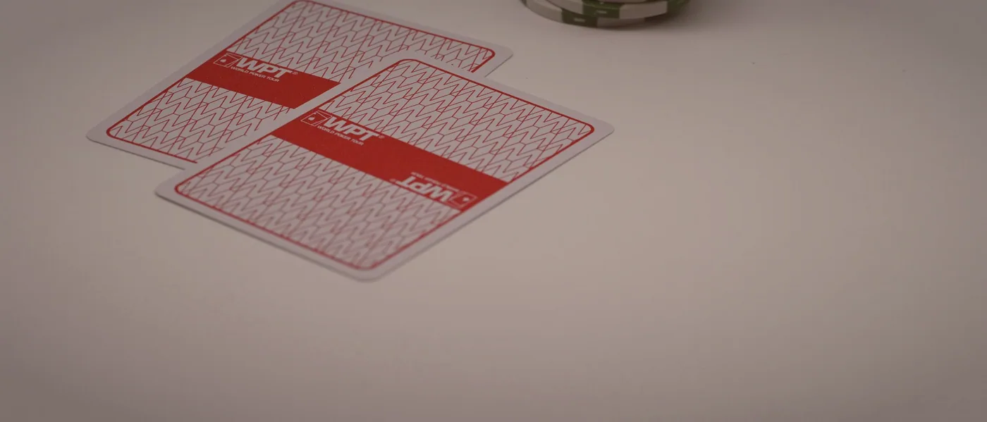 Hand of euchre being played at a felt table
